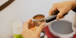 A barista making a cup of coffee