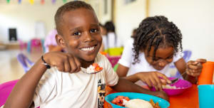 A boy eating in a clean environment.