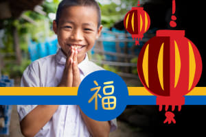 A Lunar New Year graphic that includes a photo of a boy in Thailand with Chinese lanterns and the Chinese character for "blessing" overlaid.