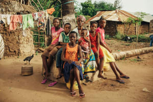 A large family sits in their yard in Kenya.
