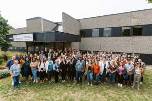 A group photo of the Compassion Canada staff team in front of the office in London, Ontario.