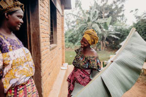 A woman smiles as she greets her neighbour.