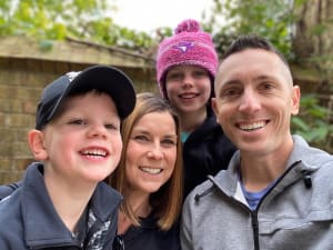 John with his wife and two kids.
