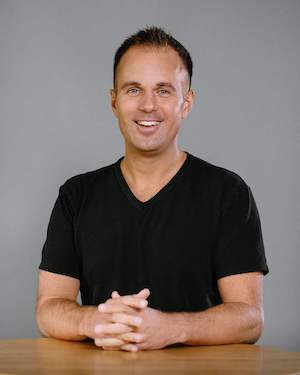 A portrait of Jeff wearing a black t-shirt.
