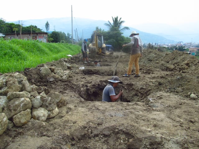 Workers dig and prepare the holes for footings