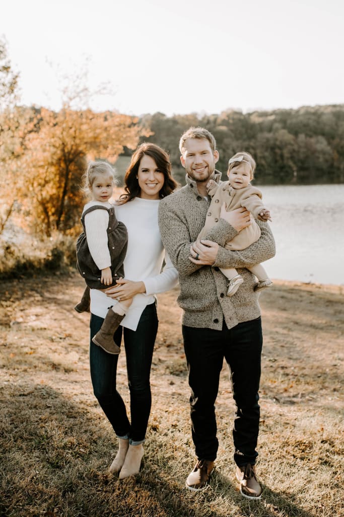 James and April Reimer pose for a family portrait with their daughters.