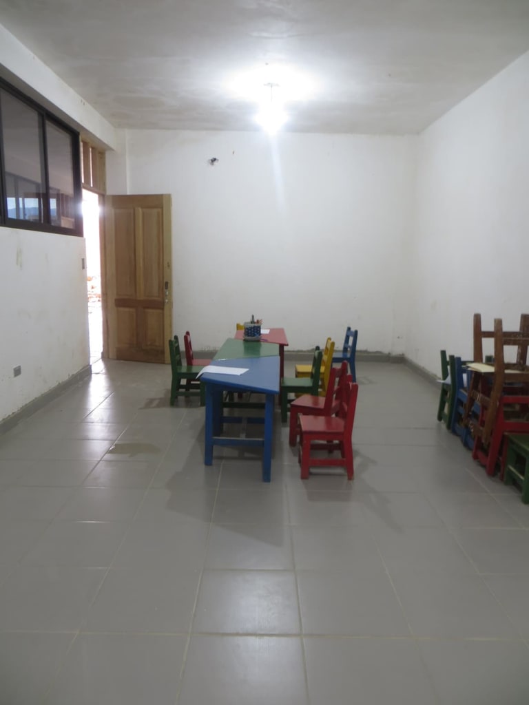 Empty sunday school room with small tables and chairs.
